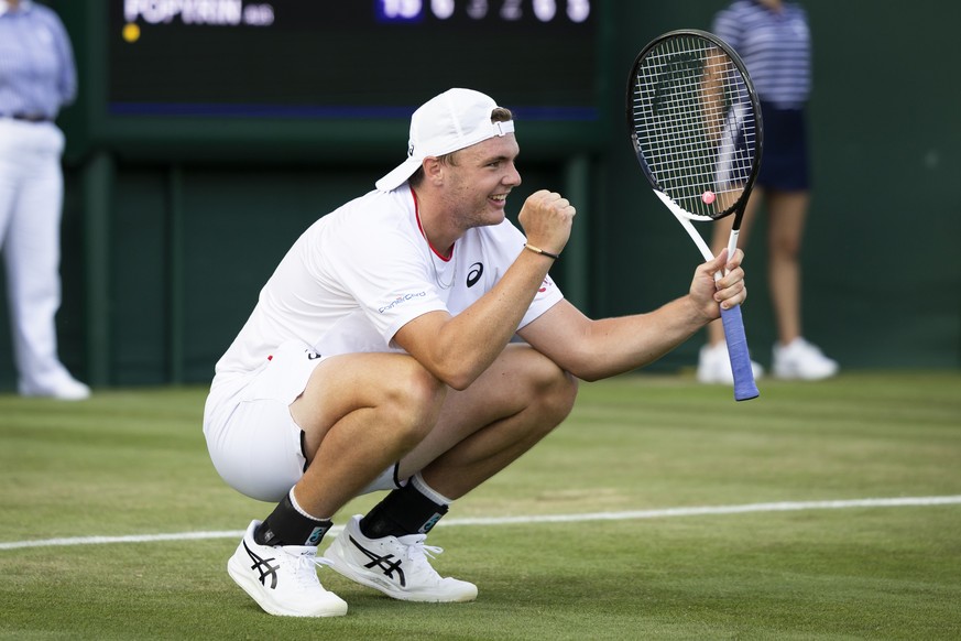 Dominic Stricker of Switzerland celebrates after winning his first round match against Alexei Popyrin of Australia at the All England Lawn Tennis Championships in Wimbledon, London, Wednesday, July 5, ...