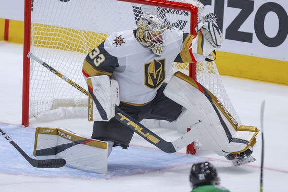 Vegas Golden Knights goalie Adin Hill (33) gloves a shot from Dallas Stars left wing Jason Robertson during the second period of Game 4 of the NHL hockey Stanley Cup Western Conference finals Thursday ...