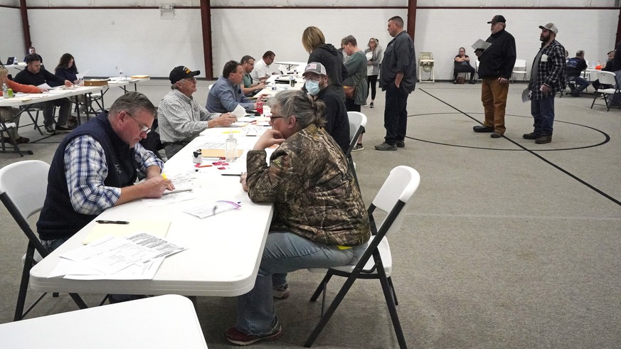 People gather at the Norfolk Southern Railways Assistance Center Thursday, Feb. 9, 2013, at the Abundant Life Fellowship in East Palestine, Ohio. Cleanup continues of a Norfolk Southern freight train  ...