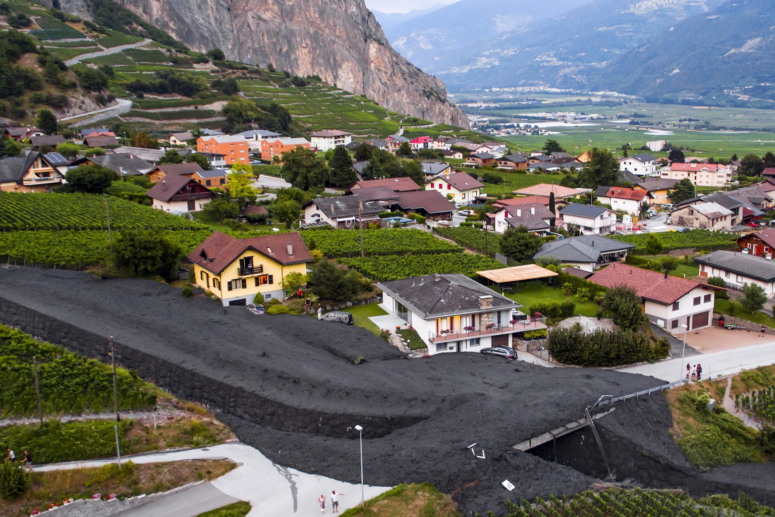 epa06937446 An aerial view taken with a drone shows the river Losentse, which came out of its bed and caused a mudflow in the village of Chamoson, in Valais, Switzerland, 07 August 2018 (issued 09 Aug ...