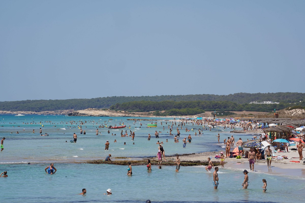 epa12243178 Tourists and sunbathers crowd Son Bou beach in Alayor, Menorca, Balearic Islands, Spain, 17 July 2025. The Balearic Islands, along with the regions of Murcia, Extremadura, Catalonia, and C ...