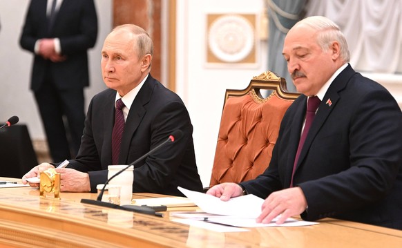 Belarusian President Alexander Lukashenko R and Russian President Vladimir Putin L make a statement during their meeting at the Palace of Independence in Minsk, Belarus, Monday, Dec. 19, 2022. Preside ...