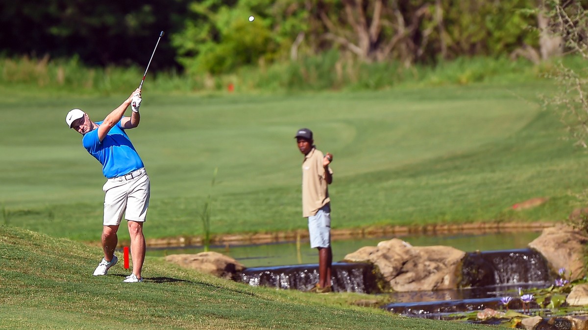 epa08032578 England's Oliver Fisher (L) plays a shot on the 13th on the second day of the Alfred Dunhill Championship at the Leopard Creek Golf Course in Nelspruit, South Africa, 29 November 2019 ...