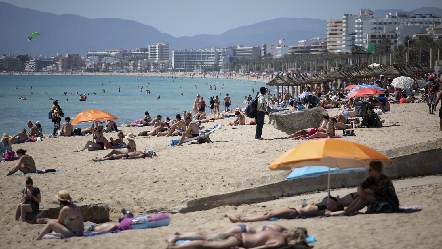 Tourists enjoy the beach at the Spanish Balearic Island of Mallorca, Spain, Monday, June 7, 2021. Spain is jumpstarting its summer tourism season by welcoming vaccinated visitors from most countries a ...