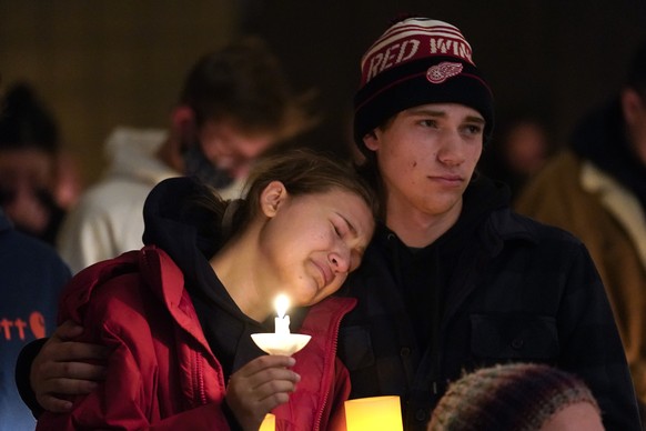 People attending a vigil embrace at LakePoint Community Church in Oxford, Mich., Tuesday, Nov. 30, 2021. Authorities say a 15-year-old sophomore opened fire at Oxford High School, killing several stud ...