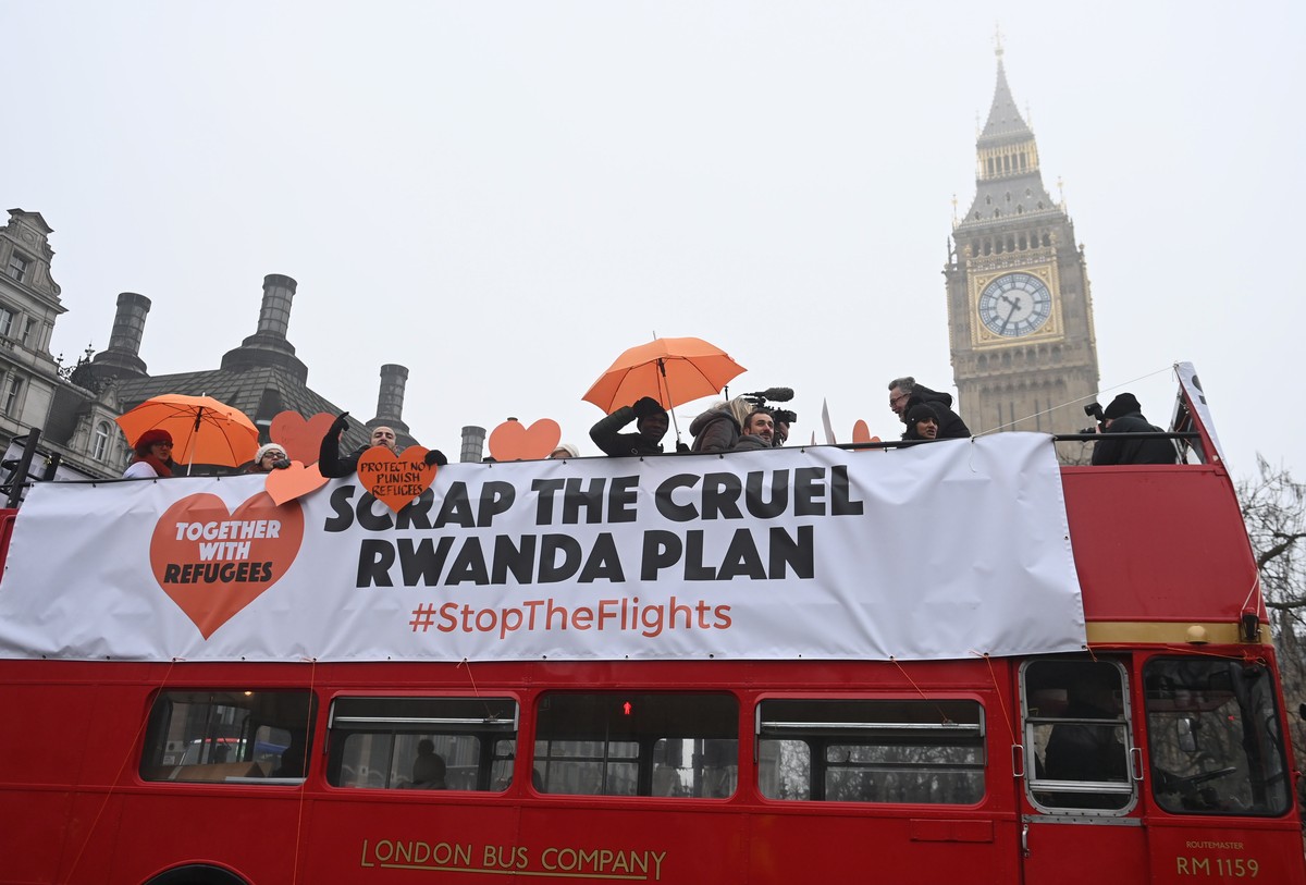 epa10428366 Activists and supporters of the refugee charity Together with Refugees ride on a bus hired for a protest in Parliament Square in London, Britain, 25 January 2023. Under a controversial dep ...