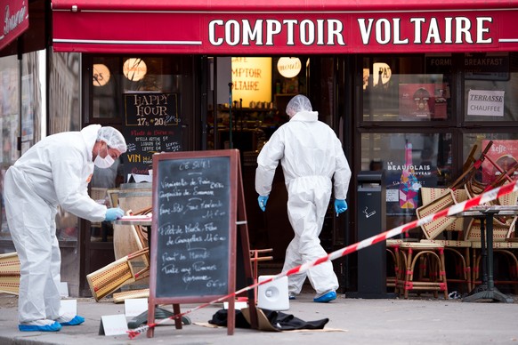 epa12519803 (FILE) - Police forensic experts work on the scene of one the shootings that took place in Paris at the Cafe Comptoir Voltaire in Paris, France, 14 November 2015 (reissued 12 November 2025 ...