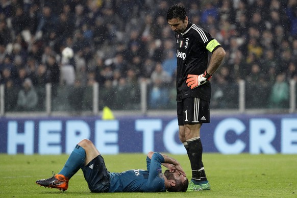 Juventus goalkeeper Gianluigi Buffon, right, looks the injured Real Madrid&#039;s Dani Carvajal during the Champions League, round of 8, first-leg soccer match between Juventus and Real Madrid at the  ...