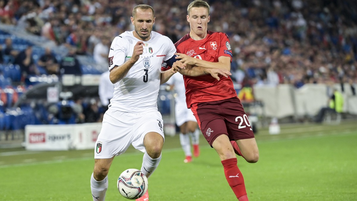 Italy's Giorgio Chiellini, left, fights for the ball against Switzerland's Michel Aebischer, during the 2022 FIFA World Cup European Qualifying Group C soccer match between Switzerland and I ...