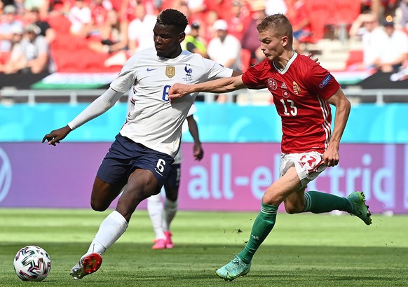 epa09285584 Paul Pogba (L) of France in action against Andras Schafer of Hungary during the UEFA EURO 2020 group F preliminary round soccer match between Hungary and France in Budapest, Hungary, 19 Ju ...