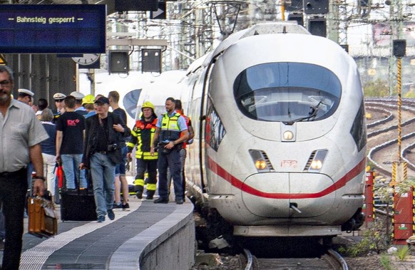 Firefighters and Police officers stay next to an ICE highspeed train at the main station in Frankfurt, Germany, Monday, July 29, 2019. German police say a child has died after apparently being pushed  ...