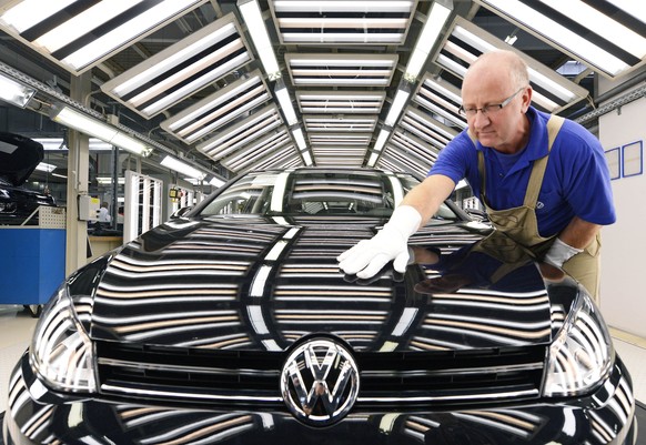 FILE - In this Nov. 9, 2012 file photo worker Michael Keil checks a Golf VII car during a press tour at the plant of the German car manufacturer Volkswagen AG (VW) in Zwickau, central Germany. Volkswa ...