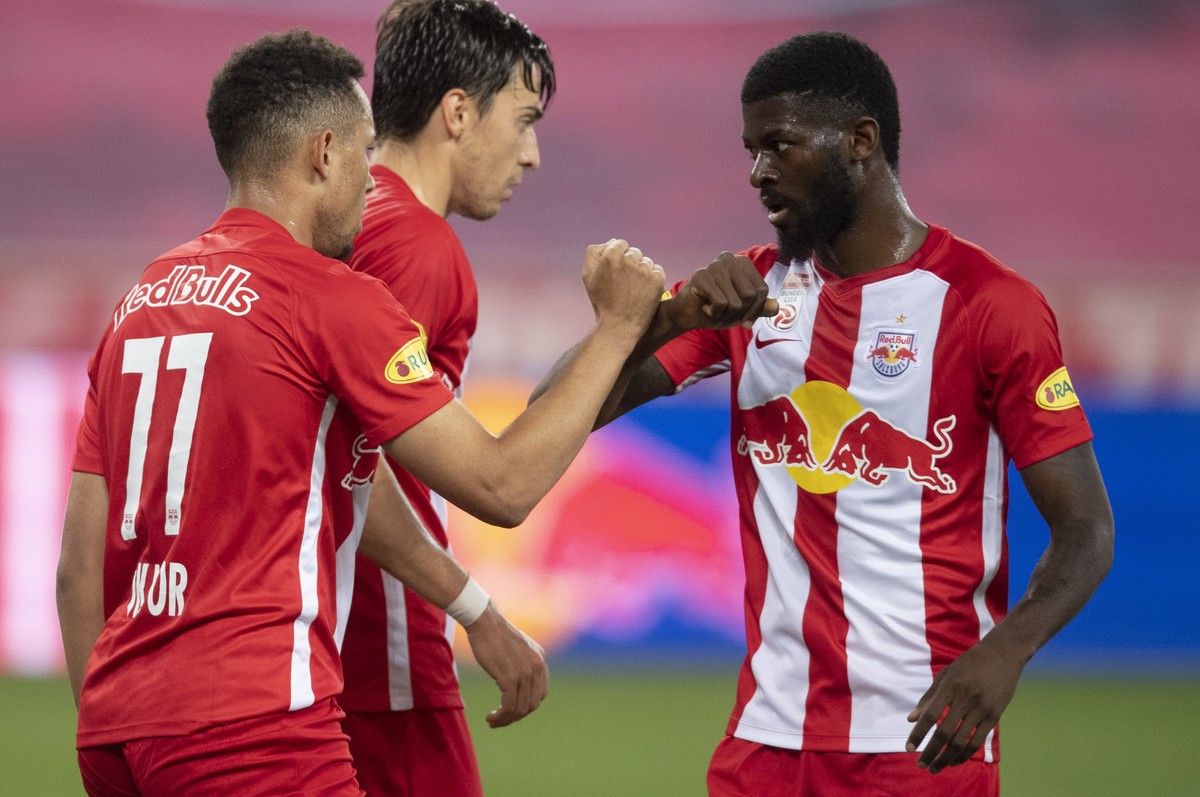 epa08463596 Salzburg's Salzburg's Noah Okafor (L) celebrates with his teammates Albert Vallci (M) and Jerome Onguene (R) after scoring on the goal for 2:0 during the Austrian first division  ...