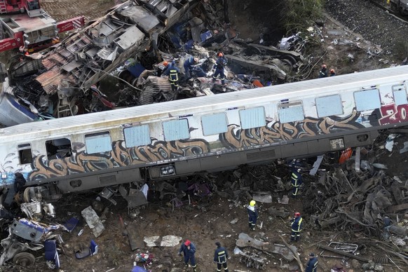 Firefighters and rescuers operate after a collision in Tempe near Larissa city, Greece, Wednesday, March 1, 2023. A train carrying hundreds of passengers has collided with an oncoming freight train in ...