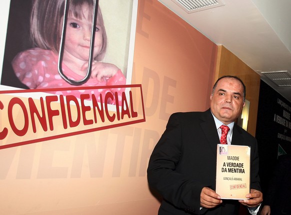 epa04260771 (FILE) A file photograph dated 24 July 2008 showing Portuguese ex- judiciary police officer, Goncalo Amaral, with a copy of his book on the disappearence of British toddler Madeleine McCan ...
