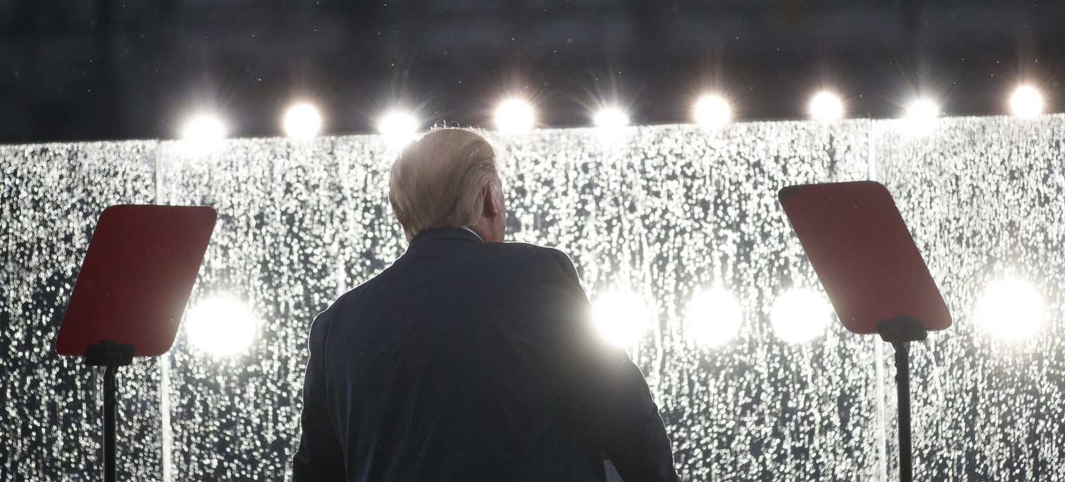 President Donald Trump speaks in the rain behind glass during an Independence Day celebration in front of the Lincoln Memorial, Thursday, July 4, 2019, in Washington. (AP Photo/Carolyn Kaster)
Donald  ...