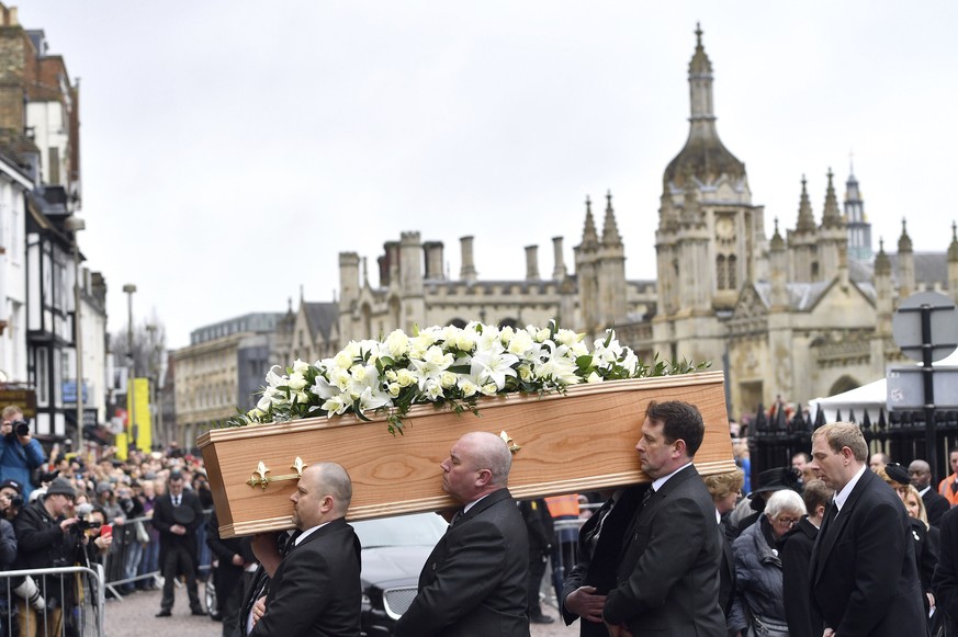 The coffin of Professor Stephen Hawking arrives at University Church of St Mary the Great as mourners gather to pay their respects, in Cambridge, England, Saturday March 31, 2018. The renowned British ...