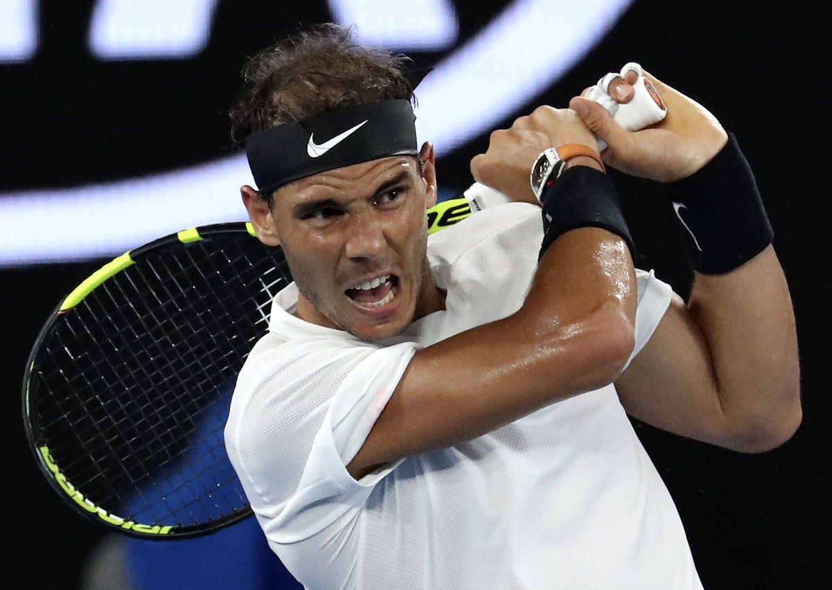 Spain's Rafael Nadal makes a backhand return to Switzerland's Roger Federer during the men's singles final at the Australian Open tennis championships in Melbourne, Australia, Sunday, J ...