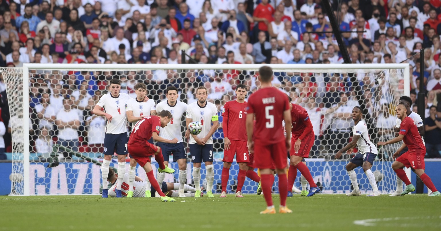 Denmark&#039;s Mikkel Damsgaard scores his side&#039;s opening goal from a free kick during the Euro 2020 soccer semifinal match between England and Denmark at Wembley stadium in London, Wednesday, Ju ...