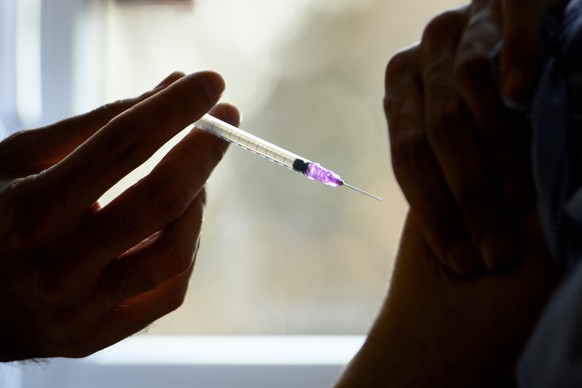 A nurse administers the Pfizer-BioNTech COVID-19 vaccine during the vaccinations against the coronavirus disease (COVID-19) on the opening day of the vaccination centers in the canton of Vaud at &quot ...