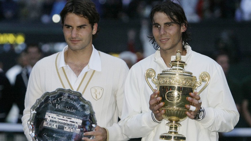 FILE - In this July 6, 2008, file photo, Switzerland&#039;s Roger Federer, left, and Spain&#039;s Rafael Nadal pose with their trophies after Nadal defeated Federer in the Men&#039;s Singles final at  ...