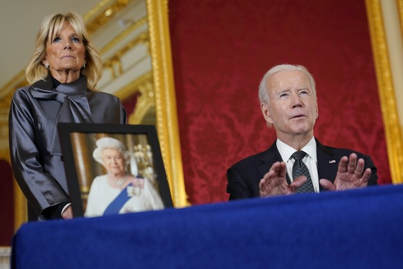 President Joe Biden signs a book of condolence at Lancaster House in London, following the death of Queen Elizabeth II, Sunday, Sept. 18, 2022, as first lady Jill Biden looks on. (AP Photo/Susan Walsh ...