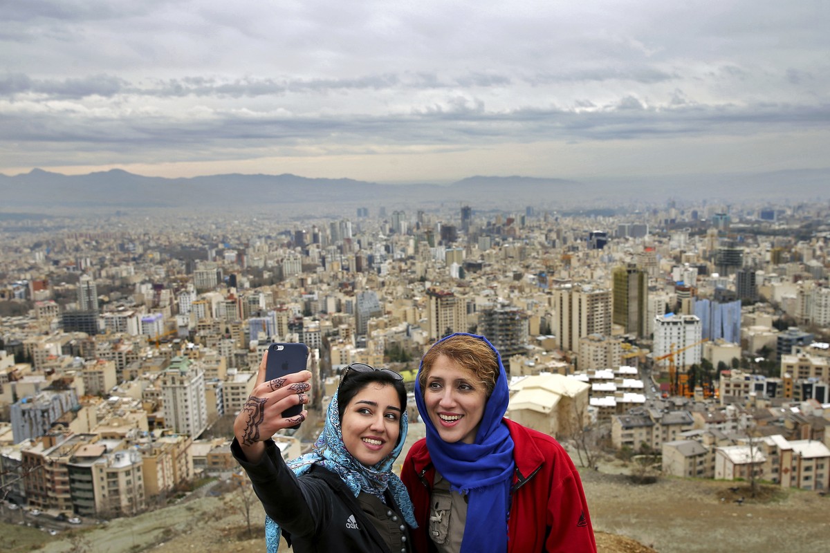 Women take selfies outdoors to observe the ancient festival of Sizdeh Bedar, an annual public picnic day on the 13th day of the Iranian new year, at the Tochal mountainous area northern Tehran, Iran,  ...