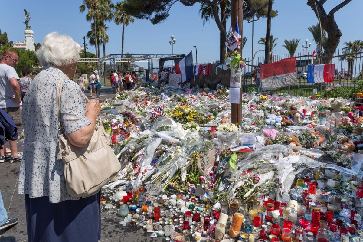 Des gens se recueillent, bougies et fleurs déposées en hommage aux 84 victimes de l'attentat du 14 juillet 2016, Kiosque de Nice le long de la Promenade des anglais dans le jardin Albert 1er, 19  ...
