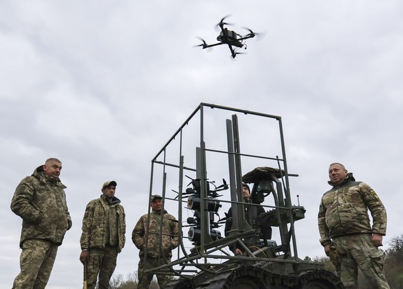 epa12881701 A handout photo made available by the press service of the 65th Separate Mechanised Brigade of the Ukrainian Armed Forces shows servicemen testing combat drones deployed from an FPV drone  ...