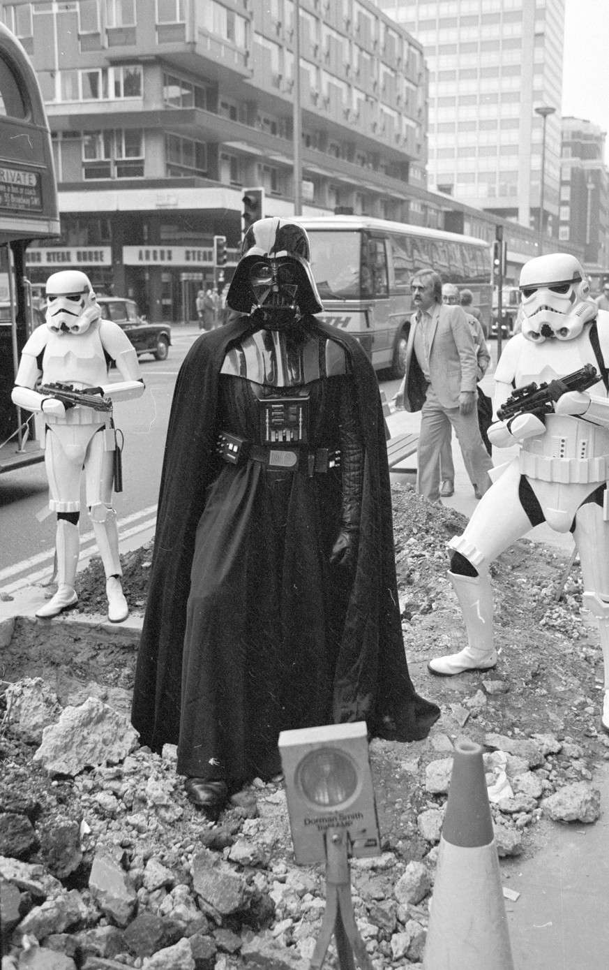 Darth Vader
31st March 1980: Darth Vader and two stormtroopers from the film 'Star Wars' stand menacingly over some road works in London's Oxford Street. (Photo by Central Press/Getty I ...