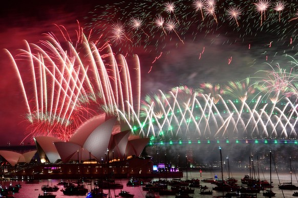 epa10383778 Midnight fireworks lit the sky over the Sydney Opera House and Sydney Harbour Bridge during New Year&#039;s Eve celebrations in Sydney, New South Wales, Australia, 01 January 2023. EPA/BIA ...
