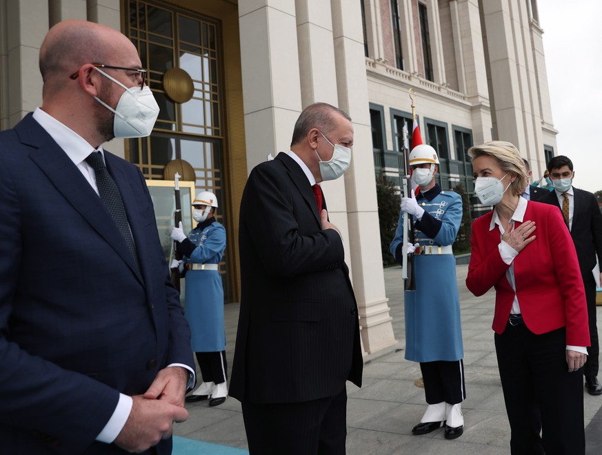 epa09118486 A handout photo made available by Turkish President Press Office shows, Turkish President Recep Tayyip Erdogan (C) welcoming EU Council President Charles Michel (L) and President of EU Com ...