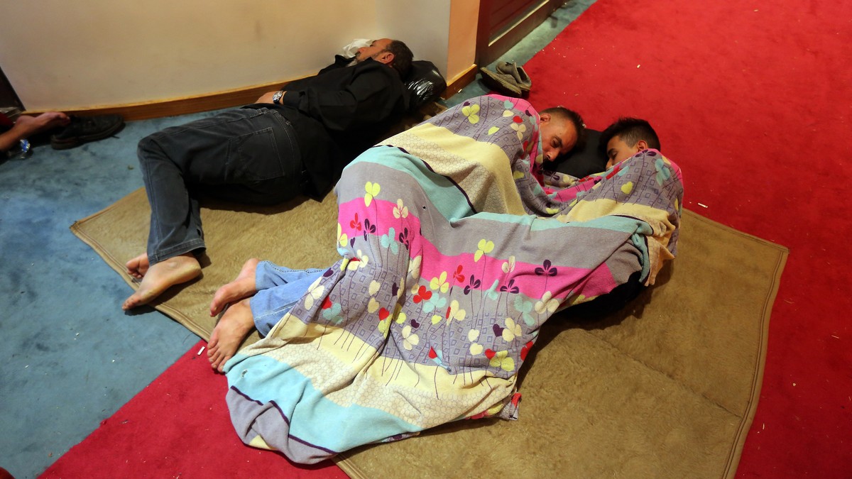 Iraqi protesters rest inside the Parliament building in Baghdad, Iraq, Sunday, July 31, 2022. Thousands of followers of an influential Shiite cleric stormed into Iraq's parliament on Saturday, fo ...