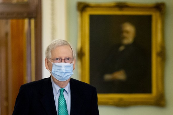 epa08894393 Senate Majority Leader Mitch McConnell walks from the Senate floor to his office on Capitol Hill in Washington, DC, USA, 19 December 2020. After passing a two-day stopgap funding bill, Con ...