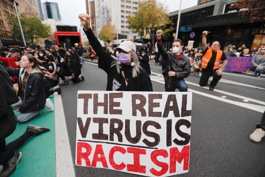 Demonstrators gesture during a march in central Auckland, New Zealand, Monday, June 1, 2020, to protest the death of United States' George Floyd, a black man who died in police custody in Minneap ...