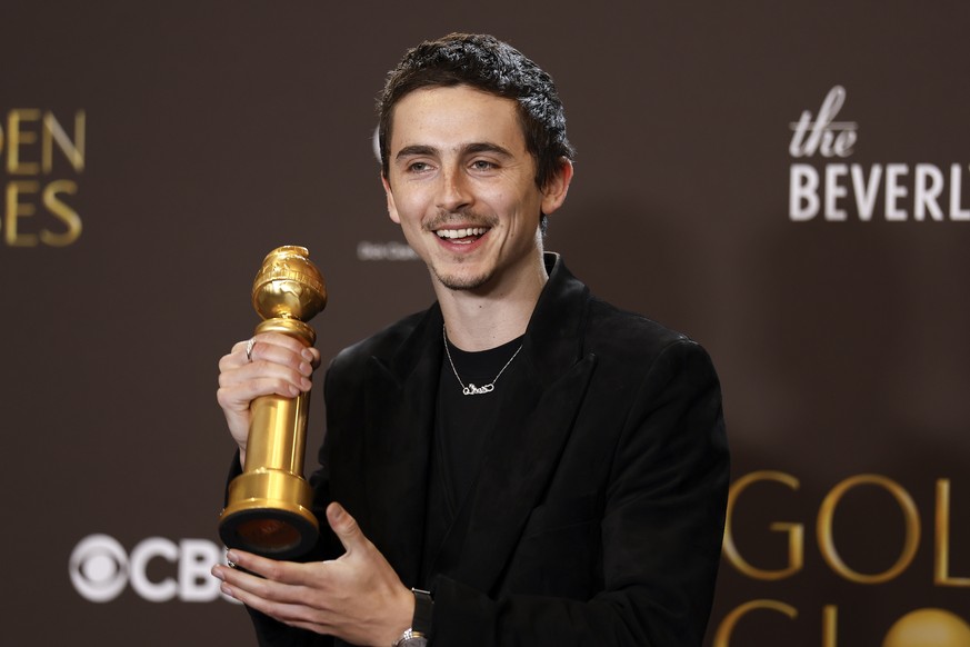 epa12643879 US-French actor Timothee Chalamet poses with the best performance by a male actor in a motion picture - musical or comedy award for 'Marty Supreme' during the 83rd annual Golden  ...