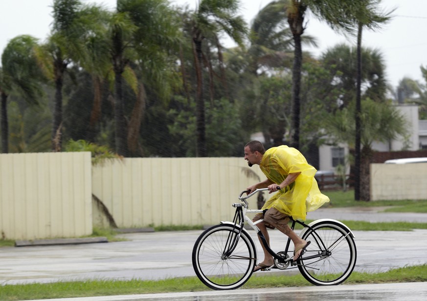 A bicycle rider makes his way through rain Thursday, Oct. 6, 2016, in Cape Canaveral, Fla., as Hurricane Matthew continues to churn its way toward Florida&#039;s east coast., (AP Photo/John Raoux)