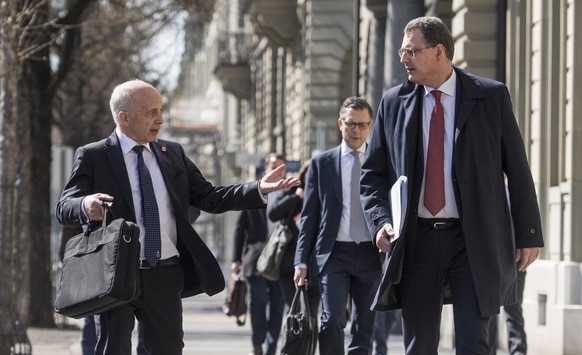 Swiss Federal councillor and finance minister Ueli Maurer, left, and Thomas Jordan, chairman of the governing board of the Swiss National Bank, walk to a media brief about the latest economic measures ...