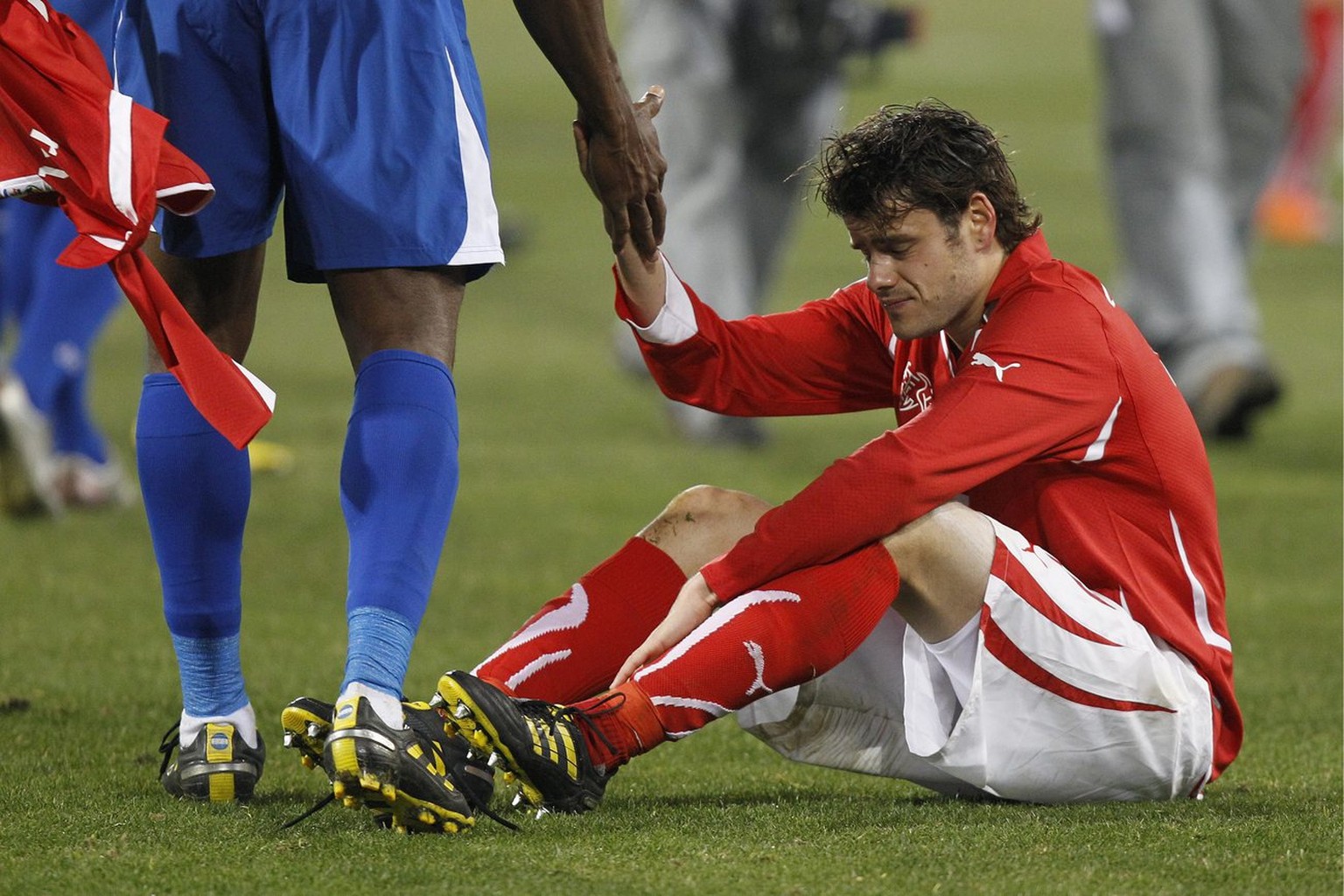 Switzerland's Tranquillo Barnetta sits on the pitch after the Group H's 2010 FIFA soccer World Cup preliminary round match between Switzerland and Honduras in the Free State Stadium in Bloem ...