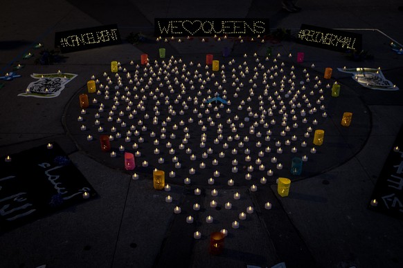 epaselect epa08436772 Candles arranged in the shape of a heart are set as a vigil honoring coronavirus victims in Queens, New York, USA, 21 May 2020. The non profit organization 'Make the Road' has or ...