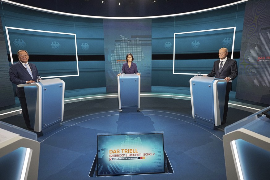 Candidates for chancellor from left, Armin Laschet, Annalena Baerbock and Olaf Scholz stand before the broadcast in the TV studio in Berlin, Sunday, Aug. 29, 2021. The debate��is the first of three ah ...