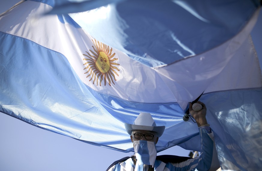 A protester demands the end of the government-ordered lockdown to curb the spread of the new coronavirus in Buenos Aires, Argentina, Thursday, July 9, 2020. People protested across the country during  ...