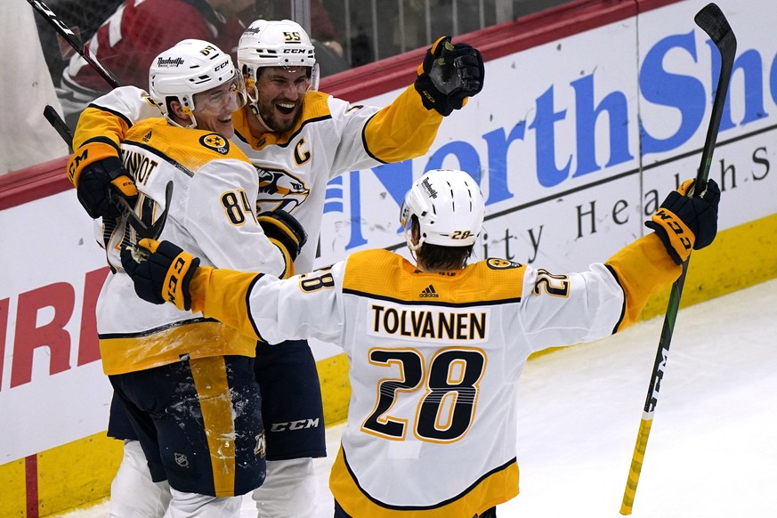 Nashville Predators left wing Tanner Jeannot (84) celebrates with defenseman Roman Josi (59) and right wing Eeli Tolvanen (28) after scoring the game-winning goal against the Chicago Blackhawks during ...