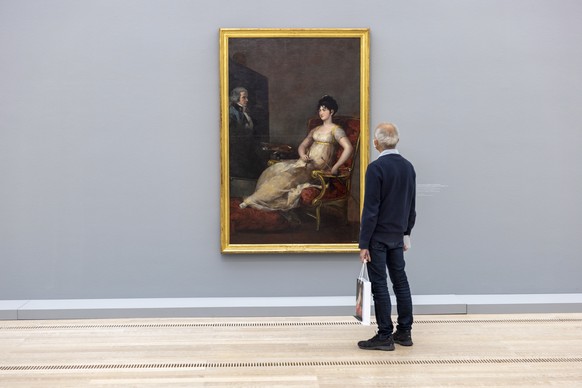 epa09511165 A visitor looks at the painting &quot;Maria Tomasa Palafox y Portocarrero, marquesa de Villafranca, pintando a su marido, 1804&quot; by Francisco de Goya at the exhibition &quot;Goya&quot; ...