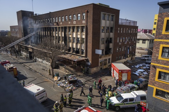 FILE - Medics and emergency works at the scene of a deadly blaze in downtown Johannesburg Thursday, Aug. 31, 2023. A man has made a shocking claim that he started the building fire in South Africa tha ...