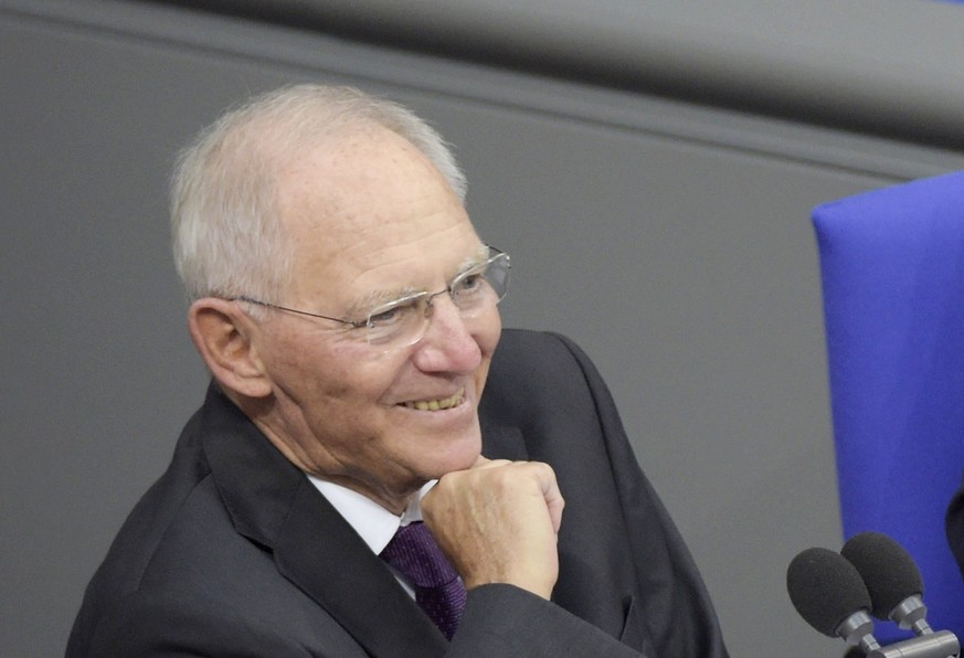 epa06285990 The newly elected President of the German Parliament of the Christian Democratic Union (CDU), Wolfgang Schaeuble, smiles next to a secretary during the constituent meeting at the Bundestag ...