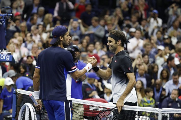 epa06180395 Roger Federer of Switzerland (R) shakes hands with Feliciano Lopez of Spain after defeating him on the sixth day of the US Open Tennis Championships at the USTA National Tennis Center in F ...