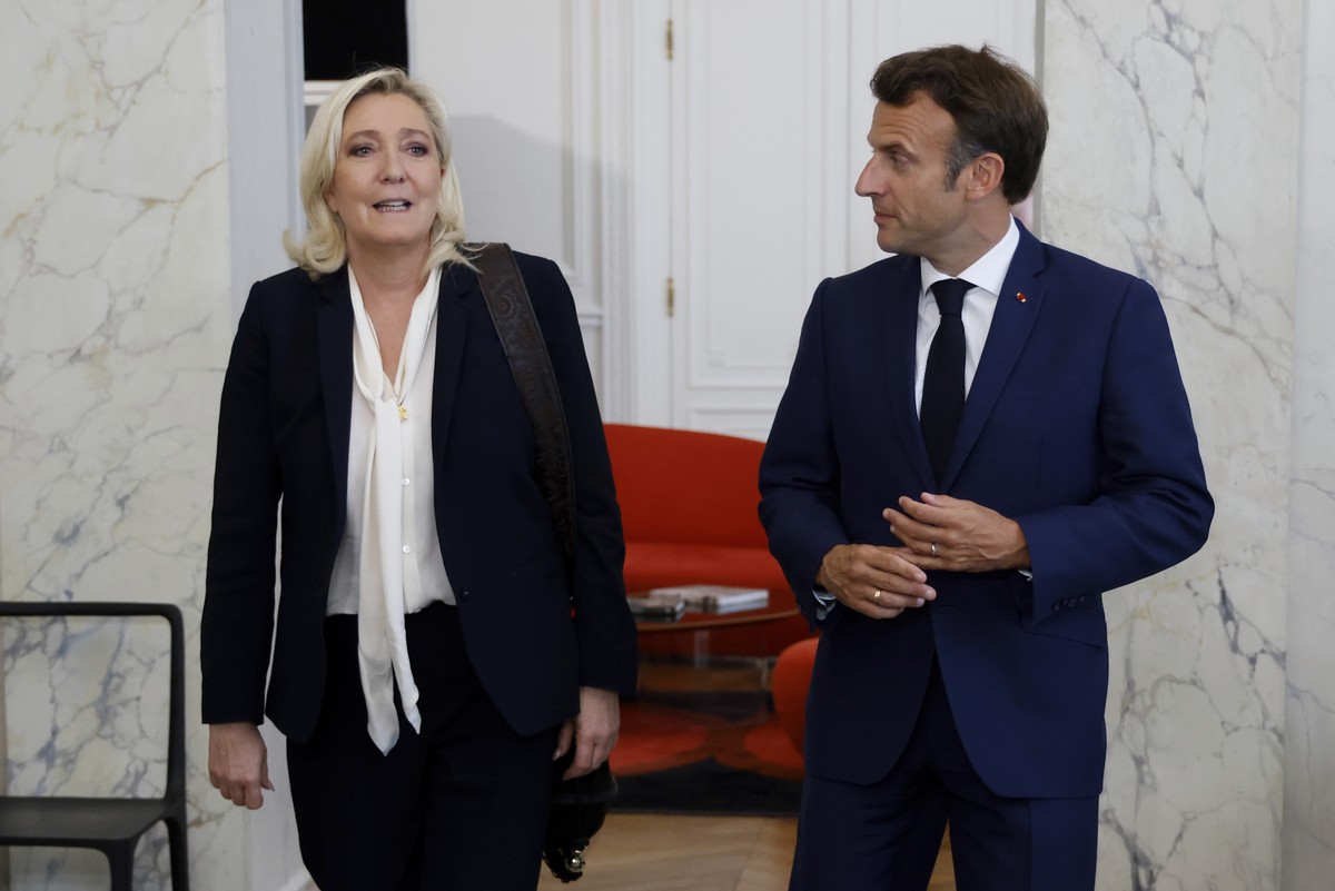 French President Emmanuel Macron, right, meets French far-right Rassemblement National (RN) leader and Member of Parliament Marine Le Pen at the Elysee Palace in Paris, France, Tuesday, June 21, 2022. ...