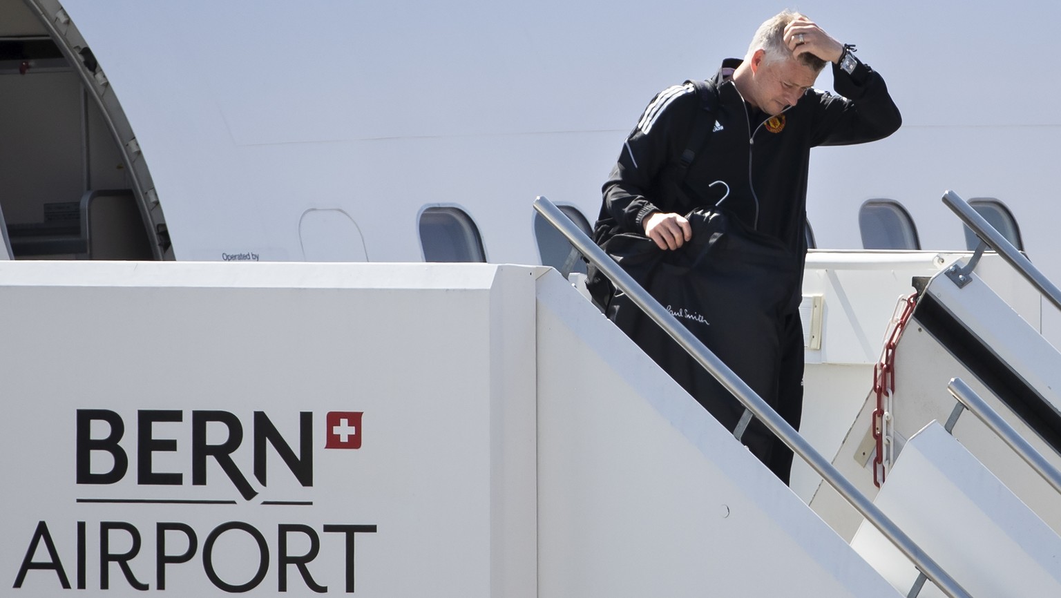 Manchester United&#039;s head coach Ole Gunnar Solskjaer disembarks from the plane upon his team&#039;s arrival at the airport in Bern-Belp, Switzerland, 13 September 2021. Manchester United will face ...