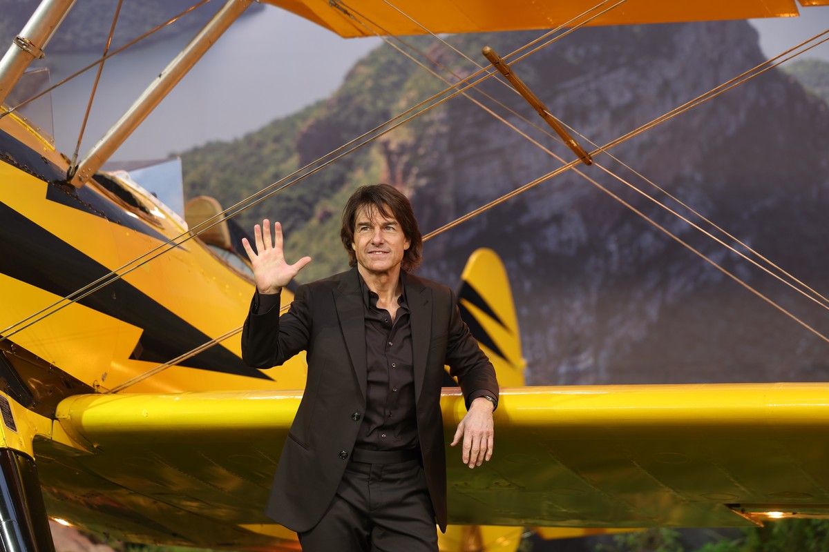 epa12103628 US actor Tom Cruise waves as he poses in front of a bi-plane at the global premiere of 'Mission: Impossible - The Final Reckoning' in Leicester Square Gardens, London, Britain, 1 ...